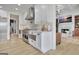 Modern kitchen with stainless steel appliances, white cabinets, and an open view to living area at 383 Beaumont Farms Dr, Sharpsburg, GA 30277