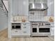 Modern kitchen features stainless steel appliances, custom cabinets, and designer tile backsplash, perfect for culinary enthusiasts at 383 Beaumont Farms Dr, Sharpsburg, GA 30277