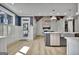 Open concept kitchen featuring a large island, modern appliances, and seamless access to outdoor area at 383 Beaumont Farms Dr, Sharpsburg, GA 30277