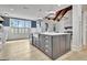 Spacious kitchen island with a sink and stainless steel appliances is showcased in an open-concept design at 383 Beaumont Farms Dr, Sharpsburg, GA 30277