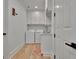 Bright laundry room features a washer, dryer, sink, cabinets and wood floors at 383 Beaumont Farms Dr, Sharpsburg, GA 30277
