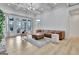 Bright living room with coffered ceilings, hardwood floors, and a walkout to a patio offers seamless living at 383 Beaumont Farms Dr, Sharpsburg, GA 30277
