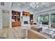 Open-concept living room with custom built-ins and a cozy fireplace provides a relaxing and inviting space at 383 Beaumont Farms Dr, Sharpsburg, GA 30277