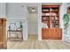 Bright living room features wood floors, custom bookshelf, and neutral wall color at 383 Beaumont Farms Dr, Sharpsburg, GA 30277