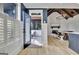 This modern living room features an open door to a deck, shiplap walls, and lots of natural light at 383 Beaumont Farms Dr, Sharpsburg, GA 30277