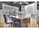 Sophisticated home office featuring a dark coffered ceiling, natural light, and classic wood desk at 383 Beaumont Farms Dr, Sharpsburg, GA 30277