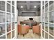 Home office with french doors, neutral paint, built-in bookshelves, and stylish furniture at 383 Beaumont Farms Dr, Sharpsburg, GA 30277