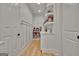 Walk-in pantry featuring custom shelving, ample storage, and neutral walls at 383 Beaumont Farms Dr, Sharpsburg, GA 30277