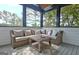 Relax on the sunroom's plush wicker seating overlooking the yard at 383 Beaumont Farms Dr, Sharpsburg, GA 30277