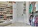 Well-organized walk-in closet with custom shelving for shoes and hanging clothes at 383 Beaumont Farms Dr, Sharpsburg, GA 30277