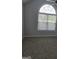 Bedroom with a large window and plush carpeting at 1601 Celestial Ct, Mcdonough, GA 30253