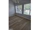 Dining area featuring bright windows with natural light and hardwood floors at 1601 Celestial Ct, Mcdonough, GA 30253