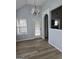 Bright dining area with luxury vinyl flooring, neutral paint, modern chandelier, and natural light at 1601 Celestial Ct, Mcdonough, GA 30253