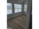 Dining area featuring luxury vinyl flooring, neutral paint, modern lighting, and multiple windows at 1601 Celestial Ct, Mcdonough, GA 30253