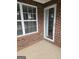 Exterior with a large window and glass door, showing brick and concrete at 1601 Celestial Ct, Mcdonough, GA 30253