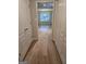 Hallway with wood-look flooring leads to room with bright natural light at 1601 Celestial Ct, Mcdonough, GA 30253
