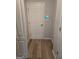 Hallway featuring a white entry door with luxury vinyl flooring at 1601 Celestial Ct, Mcdonough, GA 30253