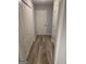 Hallway with wood floors, access to closets, and view of front door at 1601 Celestial Ct, Mcdonough, GA 30253