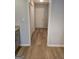 Hallway view with light wood flooring and white doors at 1601 Celestial Ct, Mcdonough, GA 30253
