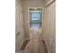 Hallway with wood-look flooring leads to room with bright natural light at 1601 Celestial Ct, Mcdonough, GA 30253