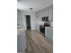 Modern kitchen featuring grey cabinets, modern stainless steel appliances, and luxury vinyl flooring at 1601 Celestial Ct, Mcdonough, GA 30253