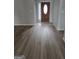 Foyer featuring hardwood floors and a wood front door at 1601 Celestial Ct, Mcdonough, GA 30253