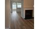 Spacious living room featuring luxury vinyl flooring, a fireplace, and an arched entryway to the dining area at 1601 Celestial Ct, Mcdonough, GA 30253