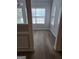 Bright room with wood-look flooring and three windows at 1601 Celestial Ct, Mcdonough, GA 30253