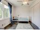 Bright Bedroom with a crib, changing table, and a large window with navy blue curtains at 1848 Winthrop Se Dr, Atlanta, GA 30316