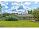 Well-maintained ranch style home featuring a lush lawn, mature trees, and a welcoming front porch at 1848 Winthrop Se Dr, Atlanta, GA 30316