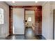 Hallway featuring sliding barn door and brick accent wall at 1848 Winthrop Se Dr, Atlanta, GA 30316