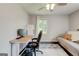 Comfortable home office setup with desk, futon, ceiling fan, and bright windows at 1848 Winthrop Se Dr, Atlanta, GA 30316