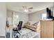 Comfortable home office setup with desk, futon, ceiling fan, and bright windows at 1848 Winthrop Se Dr, Atlanta, GA 30316