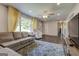 Bright living room featuring hardwood floors, a plush sectional, and large windows with stylish yellow curtains at 1848 Winthrop Se Dr, Atlanta, GA 30316