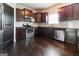 Modern kitchen features stainless steel appliances, wood cabinets and backsplash at 335 Autumn Bluff Dr, Lawrenceville, GA 30044