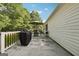 Back patio featuring grill and dining set, perfect for outdoor relaxation and entertaining, with views of mature trees at 905 Creekmore Ln, Loganville, GA 30052