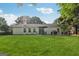 Spacious backyard featuring a well-maintained lawn, a patio with outdoor dining, and mature trees providing privacy at 905 Creekmore Ln, Loganville, GA 30052
