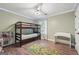 Bedroom features a bunk bed, window, wood floor, ceiling fan and playful decor for a room at 905 Creekmore Ln, Loganville, GA 30052