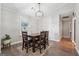 Dining room with wood floors, a window, and seating for four at 905 Creekmore Ln, Loganville, GA 30052