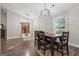 Cozy dining area featuring hardwood floors, modern lighting, and a view of the entryway at 905 Creekmore Ln, Loganville, GA 30052