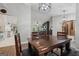 Open dining room with wood table, modern chandelier, and views to kitchen and living room at 905 Creekmore Ln, Loganville, GA 30052
