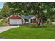 Inviting home with brick accents, a well-kept lawn, and mature trees providing shade at 905 Creekmore Ln, Loganville, GA 30052