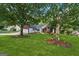 Attractive single-story home with a lush lawn and mature trees shading the front yard at 905 Creekmore Ln, Loganville, GA 30052