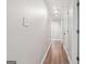 Hallway with wood floors and neutral walls leading to other rooms, offering a bright and inviting transition at 905 Creekmore Ln, Loganville, GA 30052