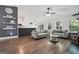 Bright living room featuring modern furniture, windows, ceiling fan and hardwood floors at 905 Creekmore Ln, Loganville, GA 30052