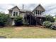 Backyard featuring a screened porch with stairs, enhanced by lush greenery and colorful hydrangea bushes at 237 Shockley Way, Dallas, GA 30157