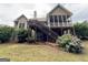 The back of the home features a charming screened porch, stairs, and well-maintained landscaping at 237 Shockley Way, Dallas, GA 30157