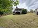 Expansive backyard featuring a two-story home with a screened porch, perfect for outdoor enjoyment and relaxation at 237 Shockley Way, Dallas, GA 30157