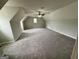 Large bonus room features plush carpeting, a ceiling fan and dormered ceiling at 237 Shockley Way, Dallas, GA 30157