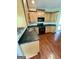Kitchen features wood floors, countertops, and backsplash with stainless steel appliances at 237 Shockley Way, Dallas, GA 30157